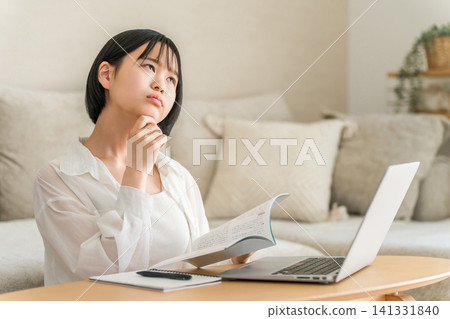 A high school girl and a middle school girl who are troubled by studying in the living room. A high school girl and a middle school girl who are troubled by studying in the living room. 141331840
