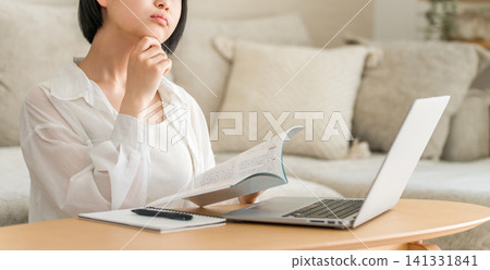 A high school girl and a middle school girl who are troubled by studying in the living room. A high school girl and a middle school girl who are troubled by studying in the living room. 141331841