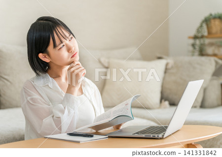 A high school girl and a middle school girl who are troubled by studying in the living room. A high school girl and a middle school girl who are troubled by studying in the living room. 141331842