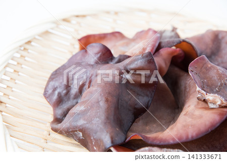 Raw wood ear mushrooms served in a colander 141333671