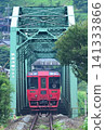 A red train running on a railway bridge 141333866