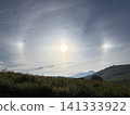 A sun dog and halo appeared over the Utsukushigahara Plateau, with summer daylilies and a blue sky. Nagano Prefecture. 141333922
