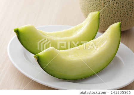 Fresh melon served on a white plate Fresh melon served on a white plate 141335565
