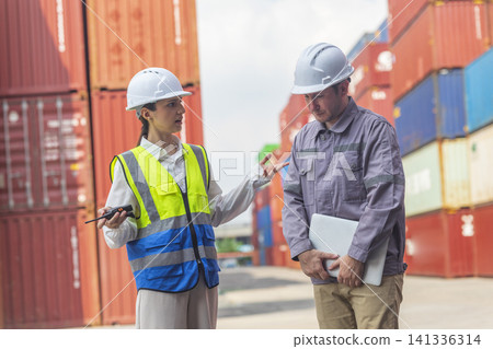 Female manager scolding and mad at foreman worker at container ship yard. Mistake and error in import-export business. Female manager scolding and mad at foreman worker at container ship yard. Mistake and error in import-export business. 141336314