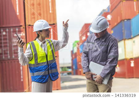 Female manager scolding and mad at foreman worker at container ship yard. Mistake and error in import-export business. Female manager scolding and mad at foreman worker at container ship yard. Mistake and error in import-export business. 141336319