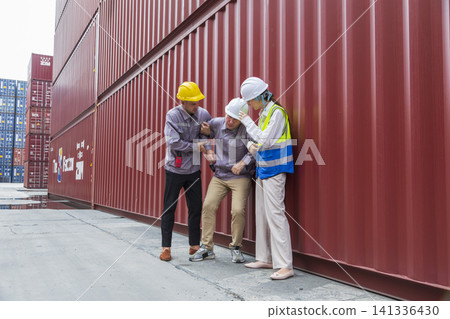 Group of workers help male worker whom faint ,sick or got accident during work, carry him to hospital.  Industrial and container work accident concept. 141336430