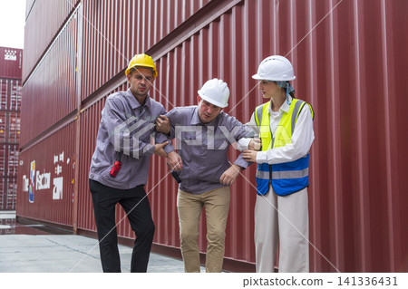Group of workers help male worker whom faint ,sick or got accident during work, carry him to hospital.  Industrial and container work accident concept. 141336431