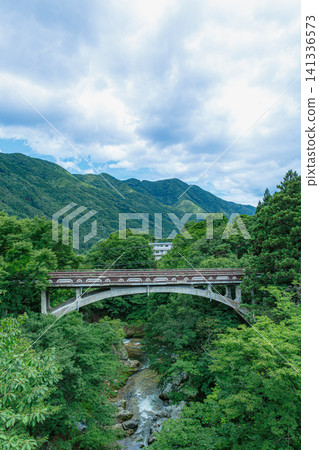 The natural scenery of Fukiware Gorge and Fukiware Falls, enveloped in the fresh greenery of summer, in Numata City, Gunma Prefecture. The natural scenery of Fukiware Gorge and Fukiware Falls, enveloped in the fresh greenery of summer, in Numata City, Gunma Prefecture. 141336573