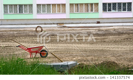 Wheelbarrow at a construction site being prepared Wheelbarrow at a construction site being prepared 141337574