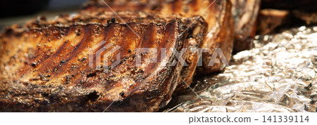Fried ribs lie on foil Fried ribs lie on foil 141339114