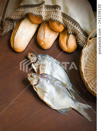 Bread and fish on the table Bread and fish on the table 141339130