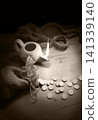 An oil lamp and silver coins 141339140