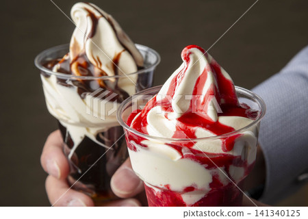 Soft serve ice cream beautifully topped with red and white sauce. Soft serve ice cream beautifully topped with red and white sauce. 141340125