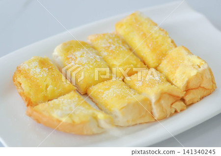 toast or bread with butter topping , toast bread or sliced bread with butter and sugar topping toast or bread with butter topping , toast bread or sliced bread with butter and sugar topping 141340245