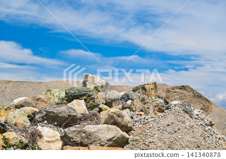 Blue sky and piles of various stones and rocks (quarry/construction materials) Blue sky and piles of various stones and rocks (quarry/construction materials) 141340878