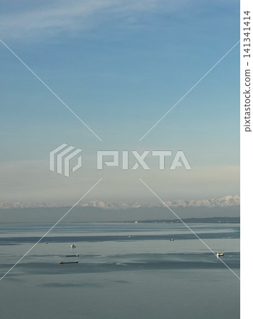 Cargo ships and boats on calm Black Sea near Batumi with distant mountains Cargo ships and boats on calm Black Sea near Batumi with distant mountains 141341414
