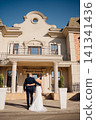 Happy and in love bride and groom at the entrance to a beautiful building  141341436
