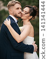 Portrait of a beautiful groom and a bride. outdoors 141341444