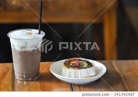 cheesecake or basque cheesecake , piece of cake or lemon cheesecake and iced chocolate or iced cocoa cheesecake or basque cheesecake , piece of cake or lemon cheesecake and iced chocolate or iced cocoa 141342487