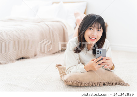 A woman using a smartphone A woman using a smartphone 141342989