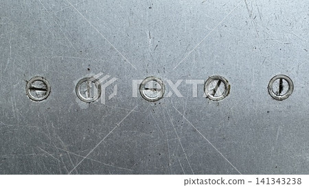 Five Worn Slotted Screws Embedded in Scratched Industrial Metal Plate Five Worn Slotted Screws Embedded in Scratched Industrial Metal Plate 141343238