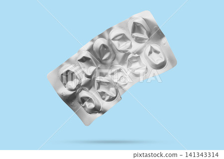 Empty medicine aluminium foil silver blister packaging isolated on blue background 141343314