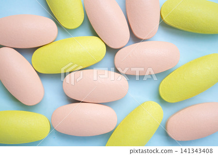 Colorful medicine pills tablet on blue background 141343408