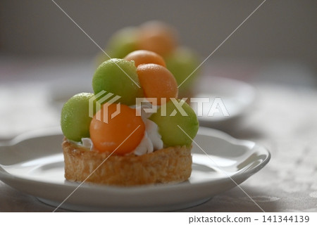 A tart cake generously filled with melon pulp. A tart cake generously filled with melon pulp. 141344139