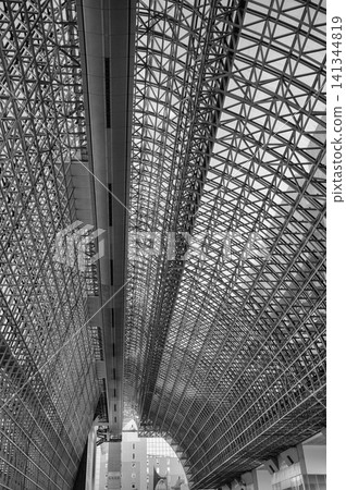 A powerful black-and-white architectural photograph capturing the futuristic steel truss structure ceiling of Kyoto Station in a vertical composition. A powerful black-and-white architectural photograph capturing the futuristic steel truss structure ceiling of Kyoto Station in a vertical composition. 141344819