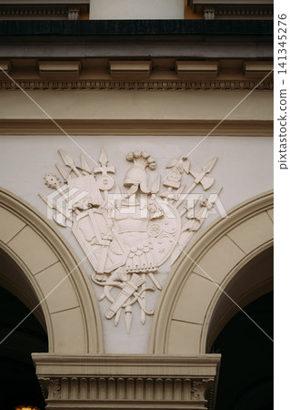 Bas-relief On Wall Of Royal Palace In Oslo, Norway. Ornate stone coat of arms carving on the Royal Palace facade in Oslo. Bas-relief On Wall Of Royal Palace In Oslo, Norway. Ornate stone coat of arms carving on the Royal Palace facade in Oslo. 141345276