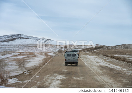 Russian Off-road van driving on the rough road that lead to Olkhon island for carrying tourist to visit Baikal lake the world's deepest lake located in southern Siberia, Russia. Russian Off-road van driving on the rough road that lead to Olkhon island for carrying tourist to visit Baikal lake the world's deepest lake located in southern Siberia, Russia. 141346185