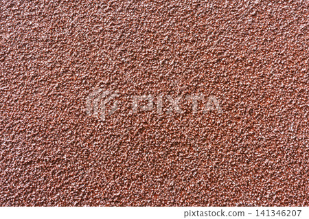 a textured, reddish-brown surface. a textured, reddish-brown surface. 141346207