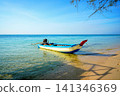 Fishing boat in turquoise sea water on sunny day near coastline in tropical Phu Quoc 141346369
