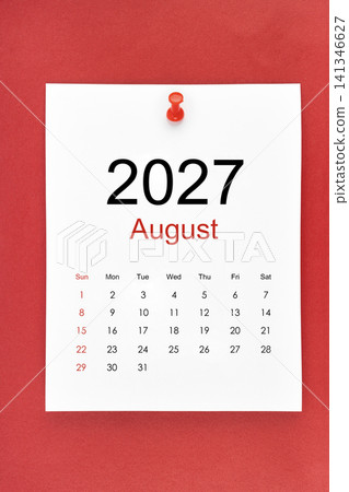 August 2027 calendar page with push pin on red color background. August 2027 calendar page with push pin on red color background. 141346627