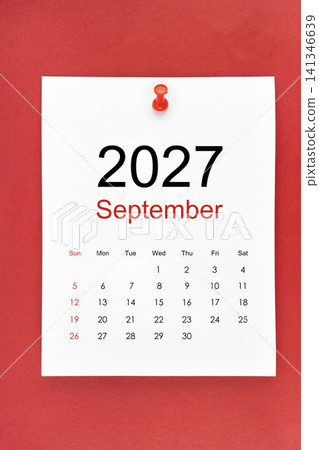 September 2027 calendar page with push pin on red color background. 141346639