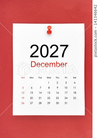 December 2027 calendar page with push pin on red color background. December 2027 calendar page with push pin on red color background. 141346642