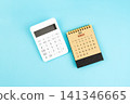 March 2027 brown caculator and white calculator on blue color background. 141346665