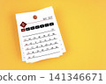 May 2027 calendar page with wooden push pin on yellow background. 141346671