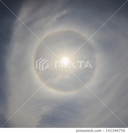 A halo surrounding the sun (22-degree halo) and thin clouds. A halo surrounding the sun (22-degree halo) and thin clouds. 141346758