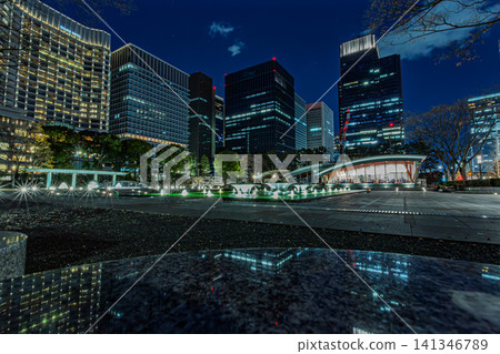 The illuminated fountain at Wadakura Fountain Park and the skyscrapers of Marunouchi, December 2023. 141346789