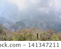 View from a high mountain on a loop road in fog in the Tianmenshan Mountains near Zhangjiajie, China 141347211