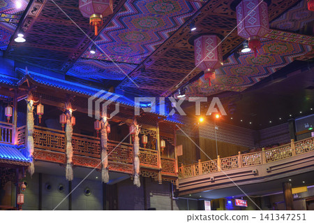Interior of a traditional Charming Xiangxi Theatre with wooden carved balconies and ceiling patterns Interior of a traditional Charming Xiangxi Theatre with wooden carved balconies and ceiling patterns 141347251