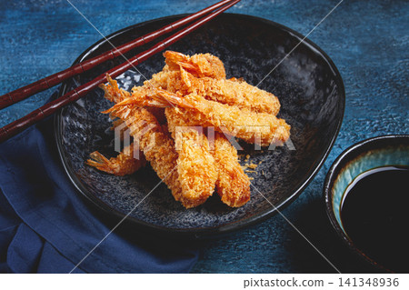 shrimp in tempura, deep fried, on a black plate, with soy sauce, close-up, top view, no people, shrimp in tempura, deep fried, on a black plate, with soy sauce, close-up, top view, no people, 141348936