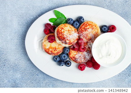 breakfast, cottage cheese cakes, with fresh berries, and sour cream, top view, close-up, no people, 141348942