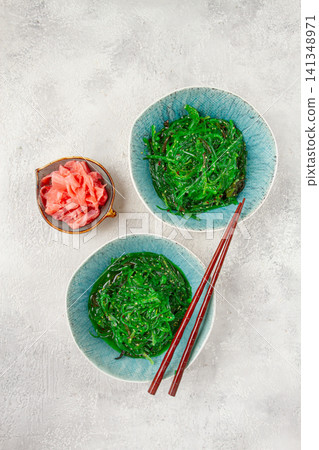Chuka salad made from fresh seaweed, with sesame dressing, two bowls with chopsticks and pickled ginger, no people, Chuka salad made from fresh seaweed, with sesame dressing, two bowls with chopsticks and pickled ginger, no people, 141348971