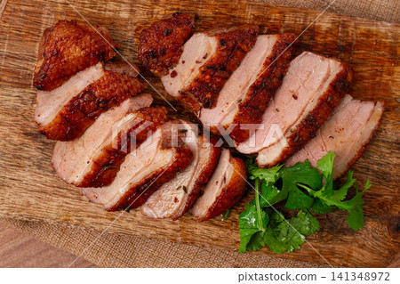Roast duck breast, sliced, on a wooden chopping board,close-up, no people, Roast duck breast, sliced, on a wooden chopping board,close-up, no people, 141348972