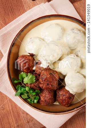 Swedish meatballs in cream sauce, plate on a wooden table, homemade, no people, Swedish meatballs in cream sauce, plate on a wooden table, homemade, no people, 141349019