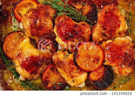 Grilled chicken thighs, baked with orange slices and thyme, on a baking sheet, homemade, no people, Grilled chicken thighs, baked with orange slices and thyme, on a baking sheet, homemade, no people, 141349028