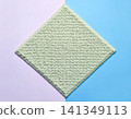 Copy space. Modern carpet in pastel colors on a white background. Home decor. Top view. 141349113