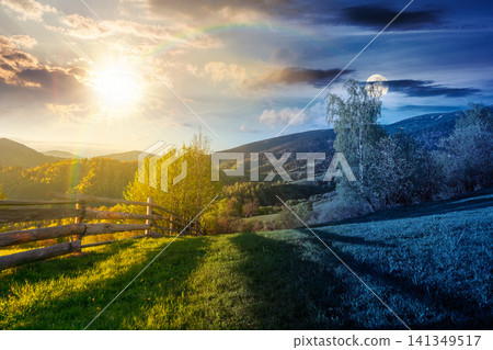 day meet night in mountainous rural landscape in spring. epic view of valley fields at twilight. sun and moon over alpine meadow. carpathian mountains countryside with forest near pasture. harmony day meet night in mountainous rural landscape in spring. epic view of valley fields at twilight. sun and moon over alpine meadow. carpathian mountains countryside with forest near pasture. harmony 141349517